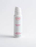 Brightening Face and Body Exfoliator blue and white striped pump bottle on a white background