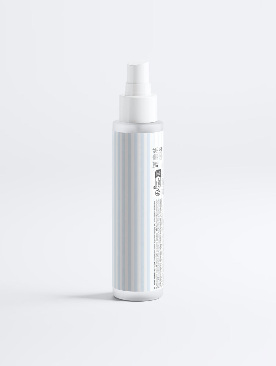 Side angle view of the Keratin Shine Leave-In Hair Mist spray bottle showcasing its professional label and pump