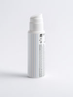 Brightening Face and Body Exfoliator blue and white striped pump bottle back view